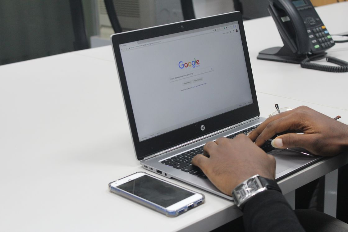 Person using his laptop to search an inquiry on Google