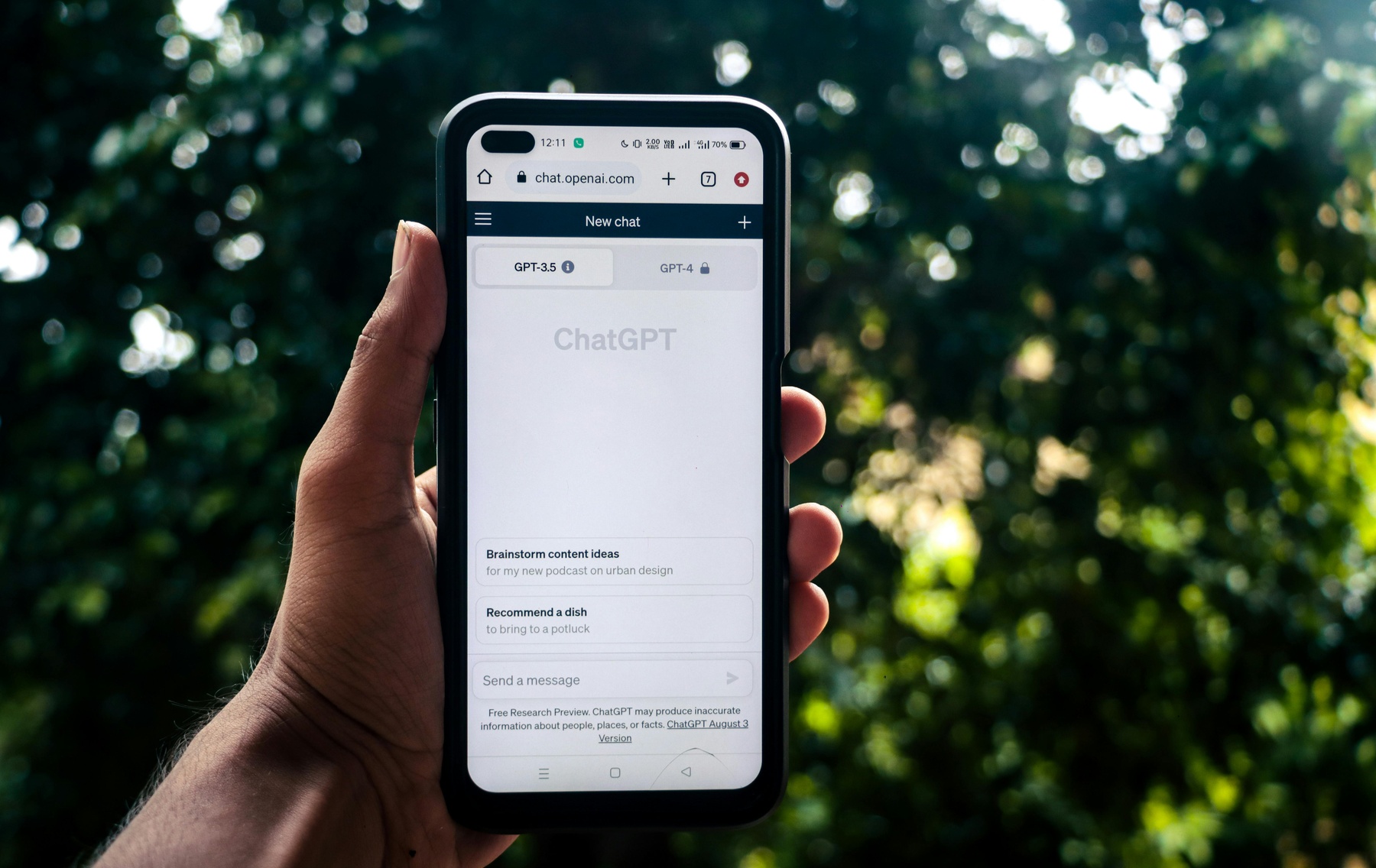 Person holding a smartphone that has the ChatGPT app open